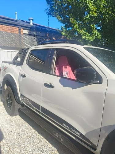 Customer's pink Waterproof Car Towel Seat Cover seen through the window of a white truck.
