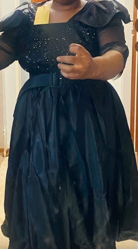 Reviewer trying on the black Plus Size Duchess Midi Dress, showing the sparkly bodice and full skirt.
