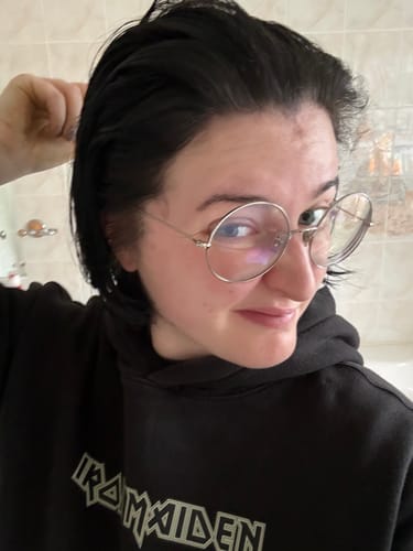 Reviewer showing their short, freshly dyed black hair after using the Instant Dye Shampoo.