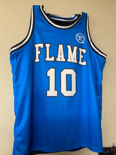 Customer's custom reversible basketball jersey showing the bright blue side with 'FLAME 10' in white.