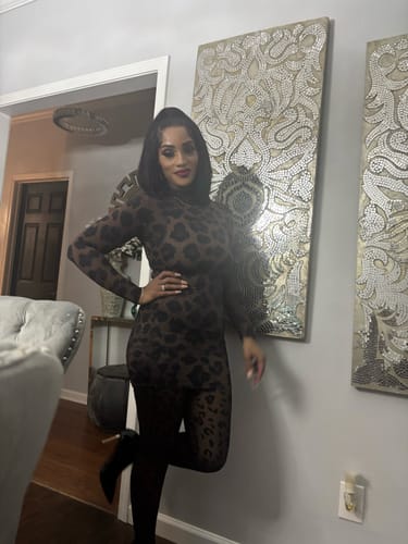 Customer posing with a hand on her hip, showing a full view of the leopard print Naked Print Mini Dress.