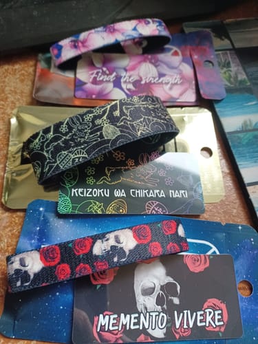 Reviewer's three bands from the Subscription Mystery 3-Pack, featuring floral, gold-patterned, and skull designs.