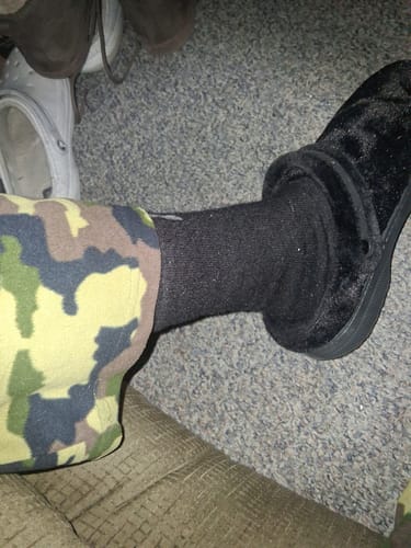 Reviewer's close-up of the black FTR Men's Alpaca Sock worn with a slipper.