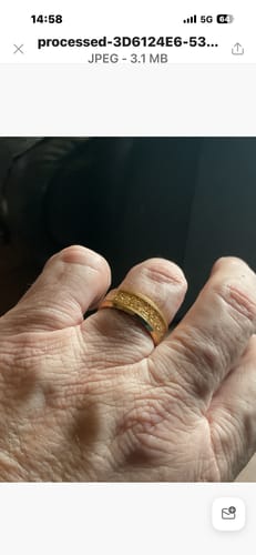 Customer's hand wearing the gold Aureum ring, showing its textured inlay.