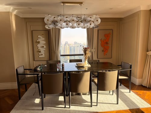 Reviewer's modern dining room from the interior design service, featuring a dining set and a stylish glass chandelier.