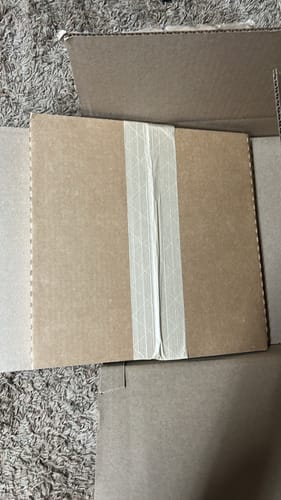 Customer shows the secure cardboard packaging for their Custom Vinyl Records.