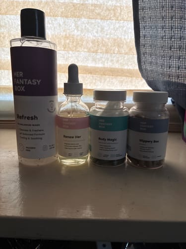 Customer's Her Fantasy Starter Kit including the wash, oil, and two supplement bottles, lined up on a shelf.