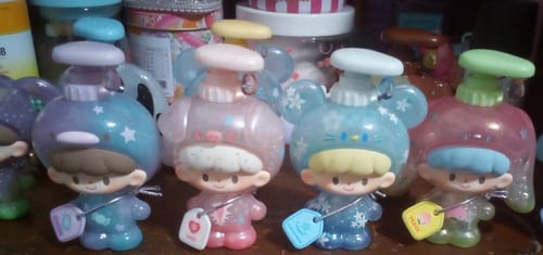Reviewer's collection of four cute, colorful zZoton Bubble Bath figures lined up on a shelf.