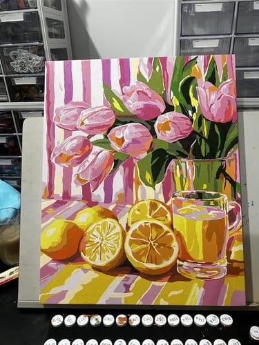 Reviewer's finished 'Juicy tulips' paint-by-number painting of pink tulips and sliced lemons on a table.