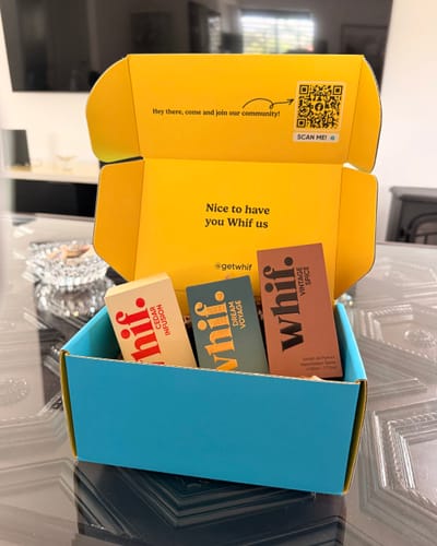 Customer's open blue and yellow Whif box showing the Dream Voyage fragrance packaging nestled inside with two other scents.