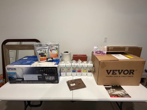 Reviewer's new DTF printing supplies, including a printer and inks, purchased after using the guide.