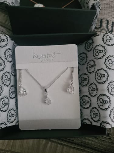 Customer's elegant Anastacia Necklace and Earrings Set with clear crystals, displayed on a card inside its gift box.