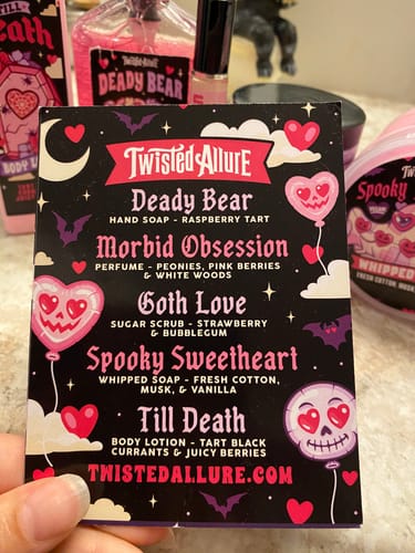 Close-up of a reviewer holding the black, spooky-themed scent card from the Monthly Subscription Box.