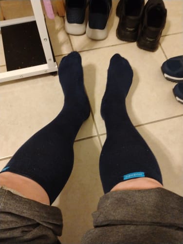 Customer's first-person view of their legs while wearing the dark blue Performance Eucalyptus Compression Socks.