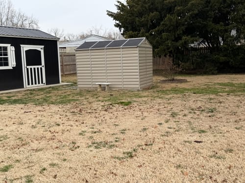 Customer's photo of two sheds in a backyard setting.