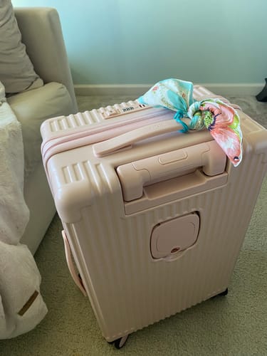 Customer's pink All-in-One Expandable Carry-On with a colorful handkerchief tied to the top handle.
