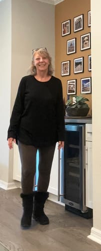 Reviewer standing indoors wearing the brown Stella Petite leggings with a black top and boots.