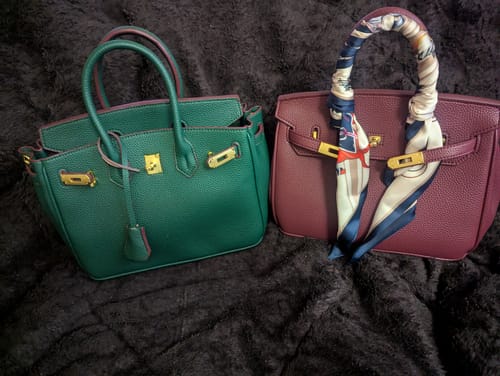Reviewer's green and maroon Warkin Bags from their collection. A scarf is tied to the handle of the maroon bag.