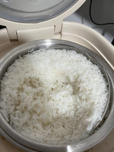 Customer shows cooked white rice in the stainless steel pot of the open Eurohauz Healthy Rice Cooker.