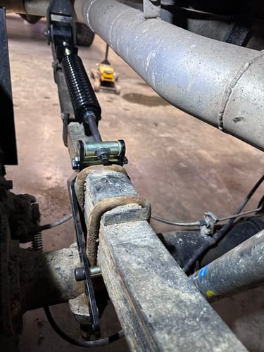 Reviewer's close-up of the installed RoadActive Suspension Kit on their vehicle's rear leaf spring.