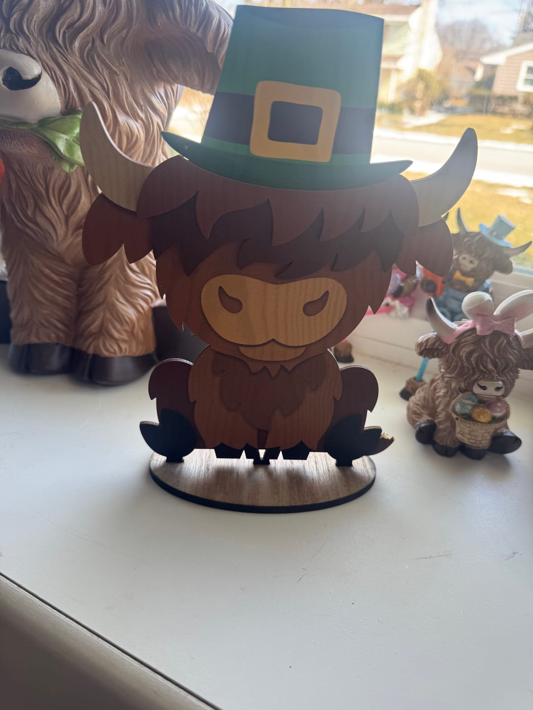 Customer photo review of 10" Highland Cow Wooden Hanger With Seasonal Hats