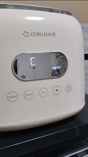 Close-up of the customer's white Eurohauz Healthy Rice Cooker, showing the lit digital display and function buttons.