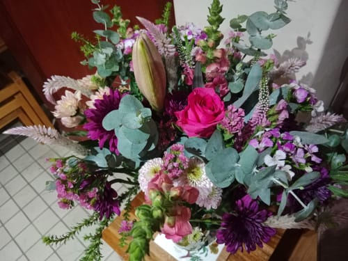 Customer's One Of A Kind Bouquet, showing a vibrant arrangement of pink, purple, and white flowers with green foliage.