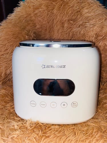Customer's white Eurohauz Healthy Rice Cooker with its lid closed, shown on a fluffy brown surface.