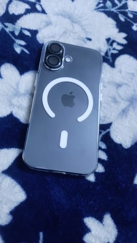 Customer's Anti Yellow Magsafe Transparent Clear Case on a dark iPhone, showing the white MagSafe ring against a floral surface.