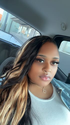 Reviewer showing their full mermaid locs style using the Ywigs Body Wave Crochet Hair with blonde streaks.
