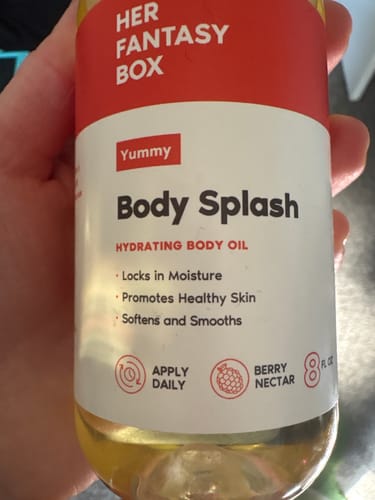 Customer's close-up of the Yummy Body Splash hydrating body oil bottle.