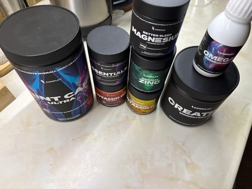 Customer's Joint Care Ultra tub on a countertop with a collection of other supplements from the same brand.