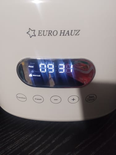 Close-up of the reviewer's white Eurohauz Healthy Rice Cooker, showing the digital display and control buttons.