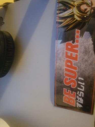 Partial view of customer's BE SUPER SLAP STICKER applied to the side of a gaming console.