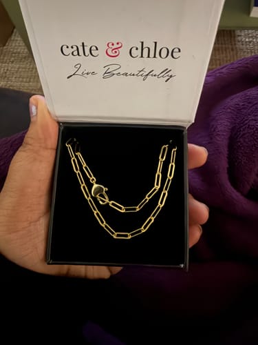 Reviewer holds open the Cate & Chloe gift box showing the gold Tammy Paperclip Chain Necklace.
