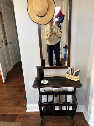 Reviewer in a mirror selfie showing the side profile and fit of the deep navy Brynn Pants.