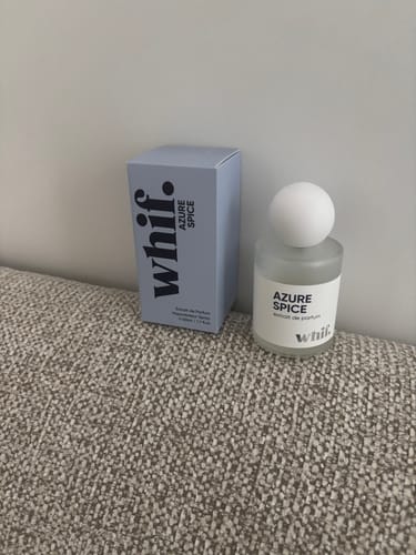 Customer's Azure Spice cologne bottle and its light blue box sitting on a textured surface.