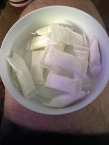 Customer's numerous Mountain Wintergreen Nicotine Pouches collected in a white bowl.