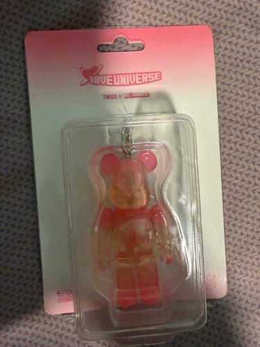 Customer's Twice x BE@RBRICK keychain, a translucent pink figure, shown in its original packaging.