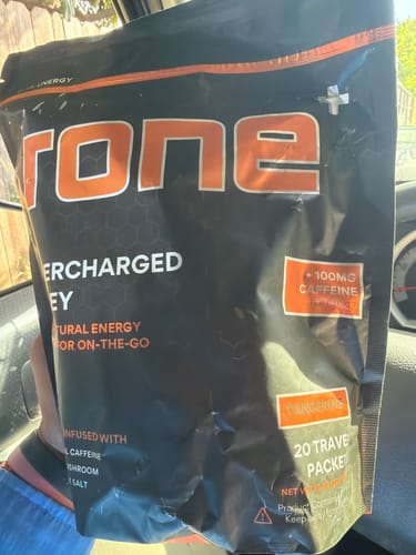 Customer holding a full bag of the Tangerine SuperCharged Honey.