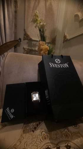 Customer's brown and rose gold Hamlet watch displayed in its black Sveston box and shopping bag.