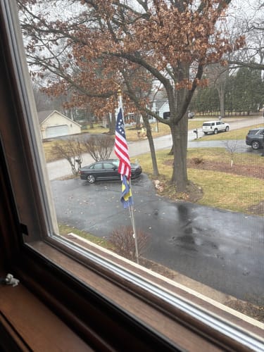 Customer's Betsy Ross flag on a flagpole in their front yard.