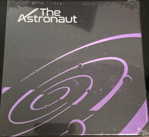 Customer's sealed copy of the BTS JIN - The Astronaut album, showing the dark cover with purple graphics.