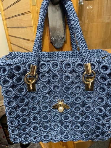 Customer's finished blue Garden Bee Crochet Bag, showing the circular pattern, gold hardware, and the pearl bee charm.