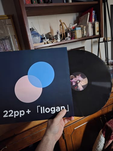 Customer holding a custom vinyl record album cover with unique art, with the vinyl disc visible.