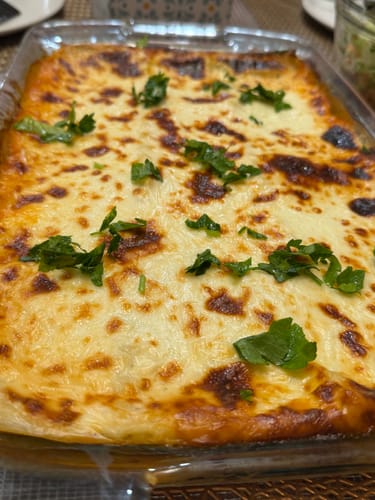 Customer's golden, baked dish prepared with Shan Seekh Kabab Recipe Mix and garnished with fresh herbs.