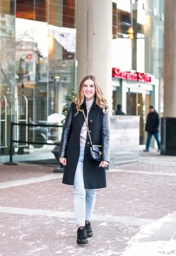 Reviewer walking outdoors in black Ortho Air shoes, styled with jeans and a long coat.
