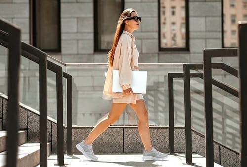 Reviewer walking outdoors in light-colored Ortho Air shoes.