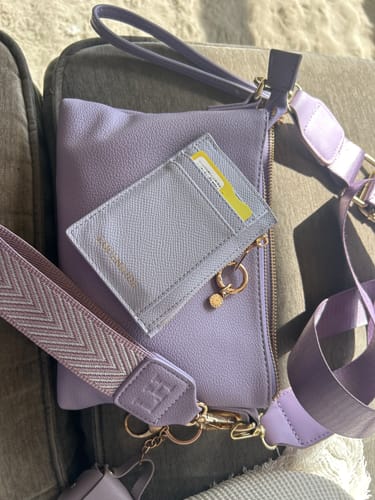 Customer's lilac Cara Cardholder resting on top of a matching lilac crossbody bag.