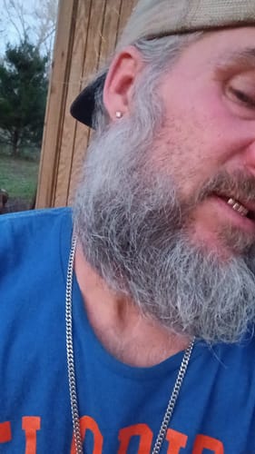 Close-up of a reviewer wearing the VVS Moissanite Solitaire Stud Earring in their ear.